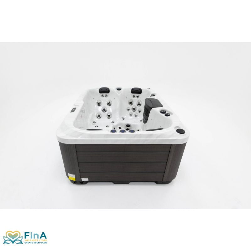 Platinum Spas Tahiti Hot Tub - elegant front view of the compact hot tub with white acrylic tub and dark cladding panel, ideal for stylish garden areas